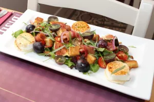 Salade van druif, gegratineerde geitenkaas, gelakt spek en verse vijgen Salade van druif, gegratineerde geitenkaas, gelakt spek en verse vijgen